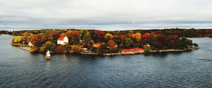 Scenic view of river by trees against sky