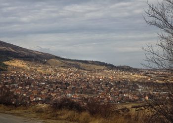 Aerial view of people in town against sky