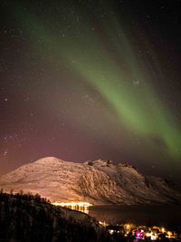 Scenic view of illuminated mountain against sky at night