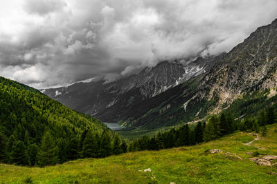 Scenic view of mountains against cloudy sky