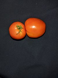 High angle view of orange tomatoes on table
