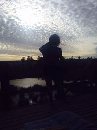 Silhouette man against sky during sunset