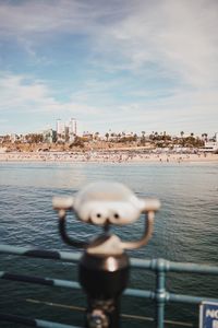 Portrait of young man in sea against cityscape