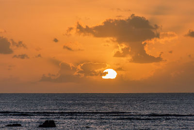 Scenic view of sea against orange sky