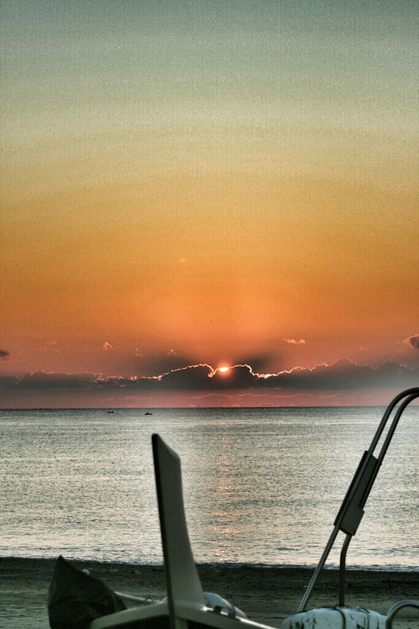 sea, sunset, water, horizon over water, orange color, beach, scenics, sky, tranquil scene, nautical vessel, beauty in nature, tranquility, nature, boat, transportation, shore, no people, outdoors, focus on foreground, idyllic