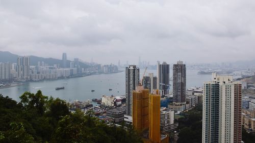 High angle view of bay and buildings against sky