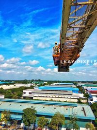 Crane at construction site against sky