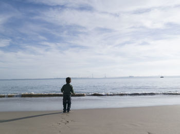 Full length of man on beach against sky