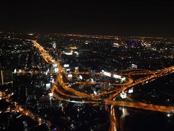 High angle view of illuminated buildings in city at night