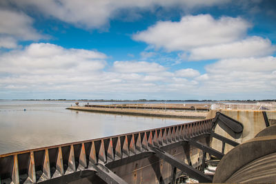 Bridge over sea against sky