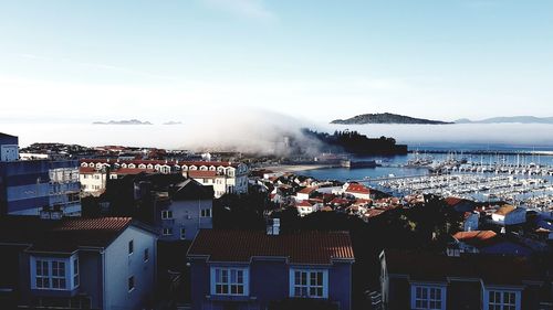 Town by sea against sky