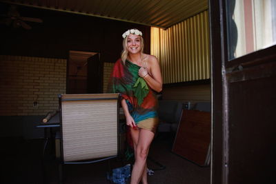 Portrait of cheerful woman standing at home