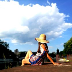 Rear view of woman wearing hat against sky