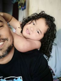 Daughter playing with father at home