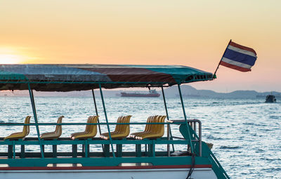 Ferry boat on sea against sky during sunset