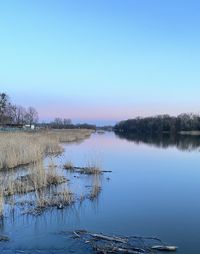 Scenic view of lake against clear blue sky