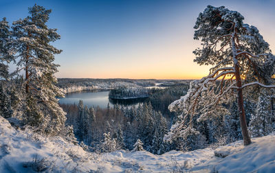 Scenic view of frozen lake against sky during sunset