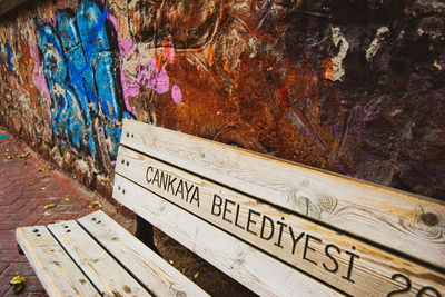 High angle view of text on old bench