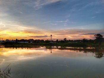 Scenic view of lake against sky during sunset