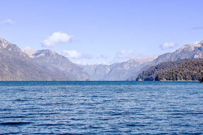 Scenic view of sea and mountains against sky