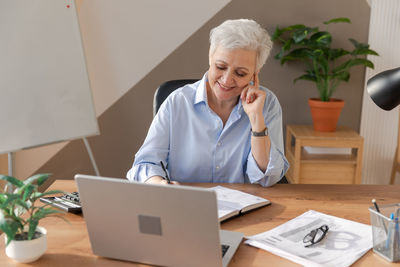 Portrait of doctor working at desk in office