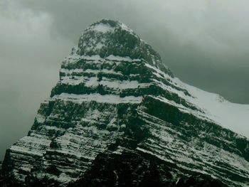 Scenic view of mountains against cloudy sky