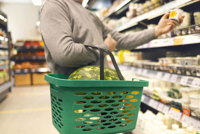 Midsection of man working at supermarket