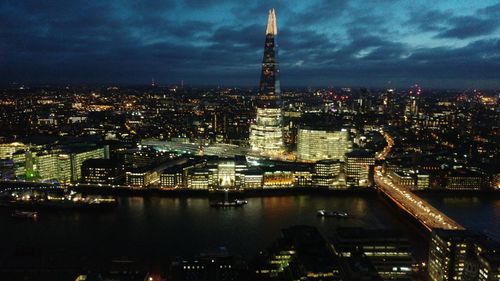 Illuminated cityscape against sky at night