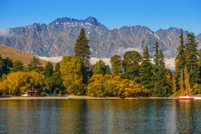 Trees by mountains against sky