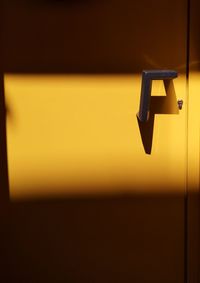 Low angle view of illuminated yellow door 