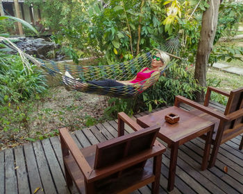 Empty chairs and tables in yard