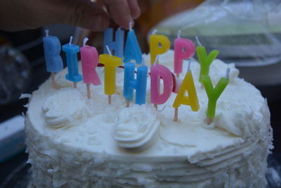 Close-up of hand holding cake