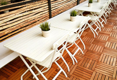 High angle view of empty chairs and table