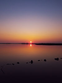 A beautiful sunset over the still waters of a wildlife reservation in virginia beach.