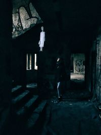 Young woman standing in abandoned building