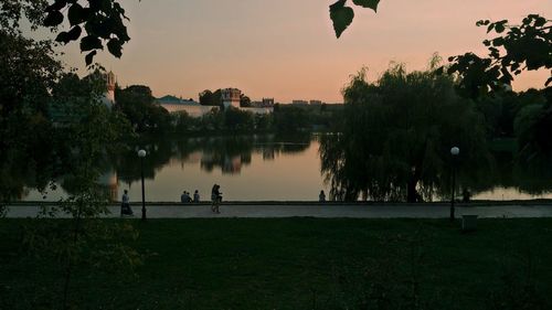 Scenic view of lake against sky at sunset