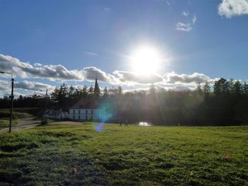 Scenic view of field against bright sun