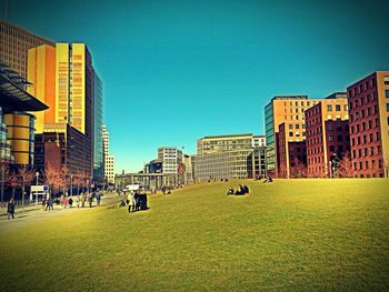 Buildings in city against blue sky