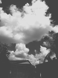 Low angle view of building against cloudy sky