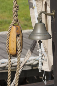 Close-up of rope tied to wooden post