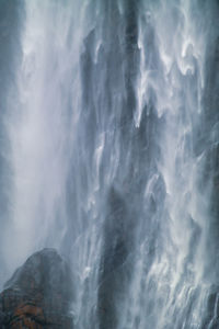 Low angle view of waterfall against sky