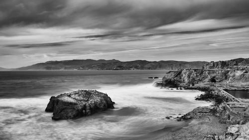 Scenic view of sea against cloudy sky