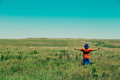 Full length of man standing on grassy field