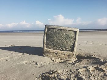 Lifeguard hut on beach against sky