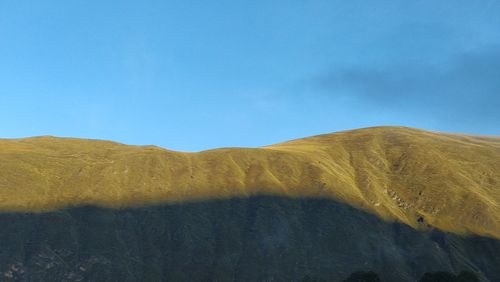 Scenic view of mountains against clear blue sky