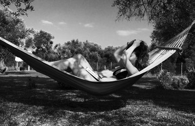 Young woman lying down in hammock