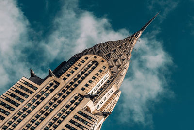 Low angle view of buildings against cloudy sky