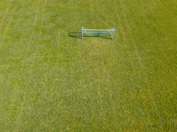 High angle view of empty bench on field