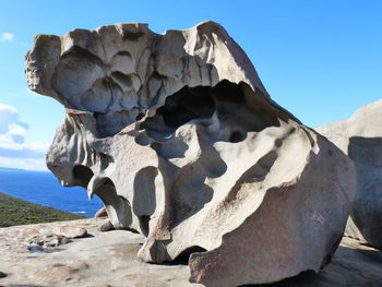 Close-up of rock formation against blue sky