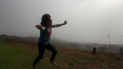 Boy playing in foggy weather